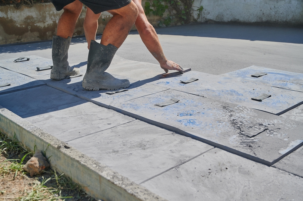 Worker,Placing,Mold,On,Printed,Concrete